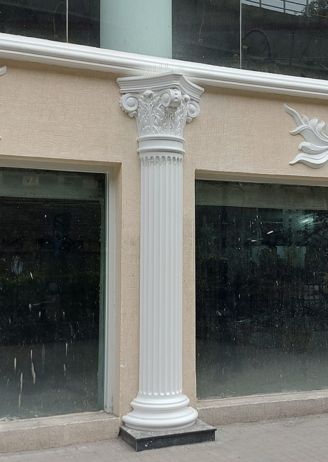 A shopfront column: moulded base, fluted shaft and Corinthian capital — 1 MG Lido Mall, Bangalore, Karnataka