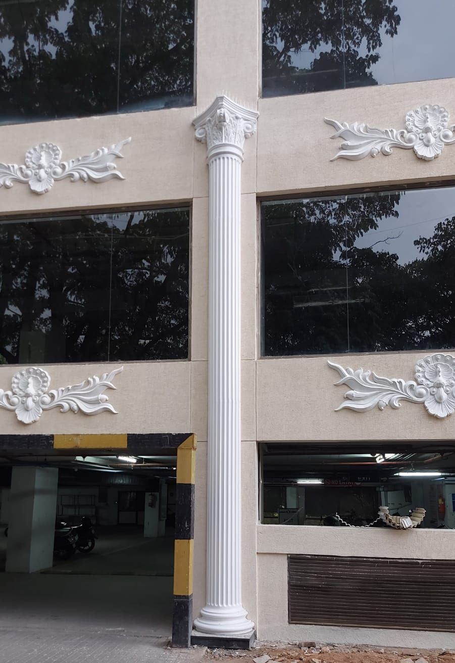 Columns and ornaments rising beside the parking entrance — 1 MG Lido Mall, Bangalore, Karnataka