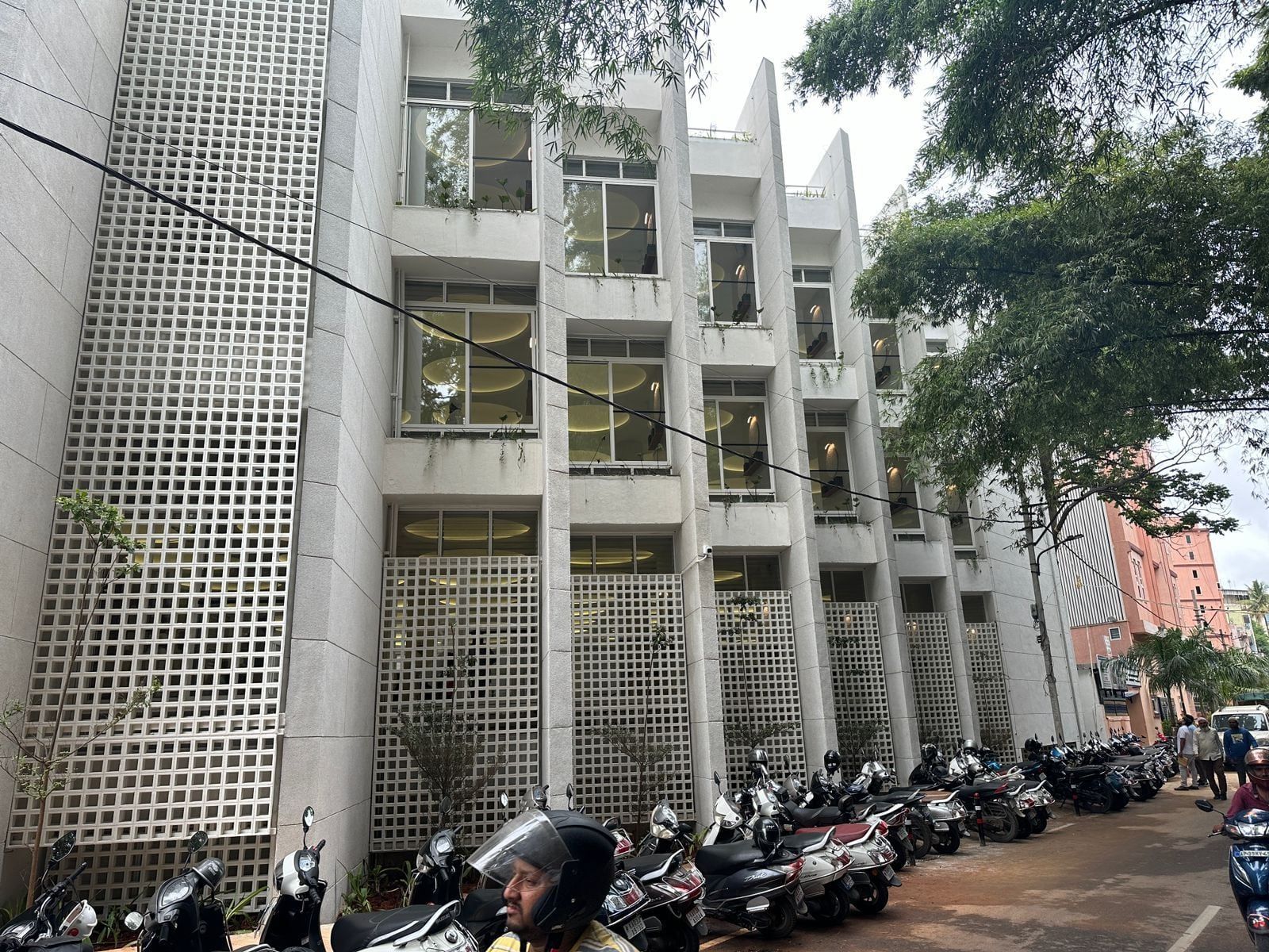 Jali screens along the street front, between the window bays — Bismilla Green Masjid
