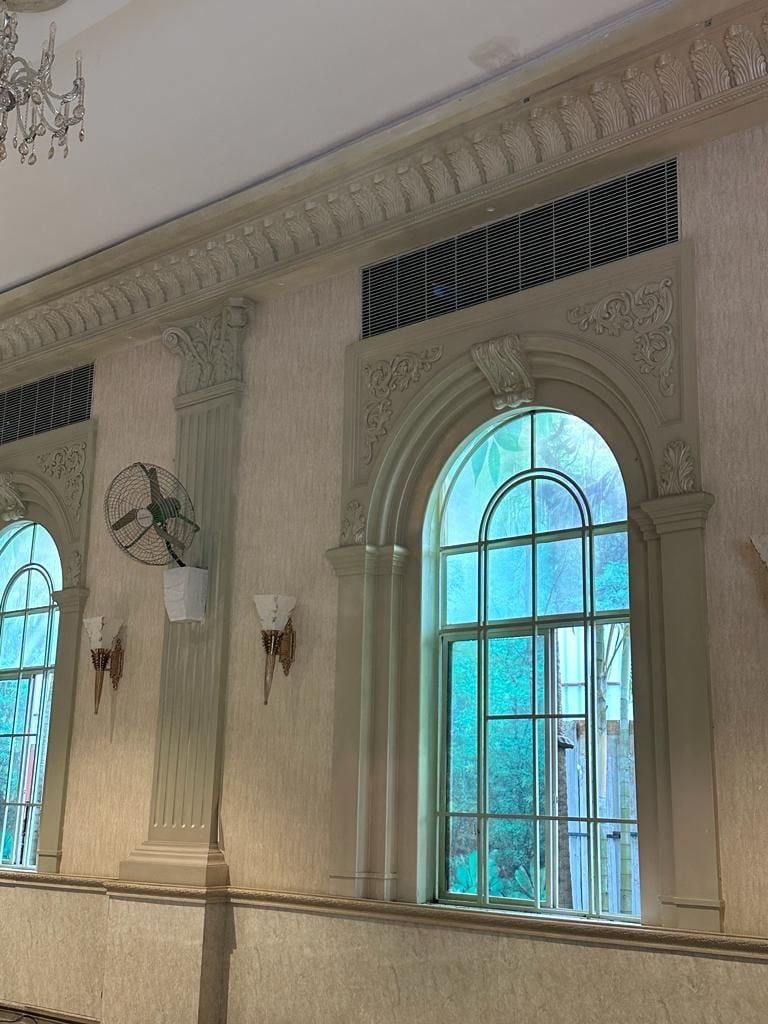 An arched window with its moulded surround and the pilasters either side — Princess Golf